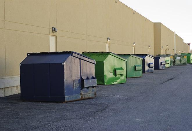 a row of heavy-duty dumpsters ready for use at a construction project in Babson Park